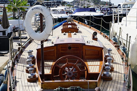 brown and white wooden boat during daytime thumbnail