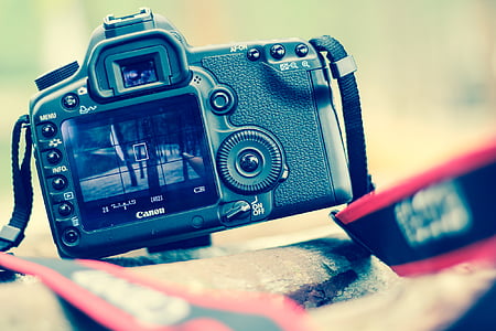 turned on black Canon DSLR camera thumbnail