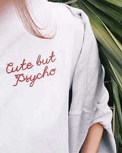 Woman Wears White Sweater Near Green Leaves thumbnail