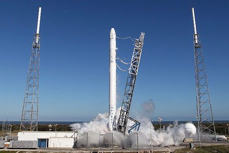 white space shuttle blowing smoke on the ground during daytime thumbnail