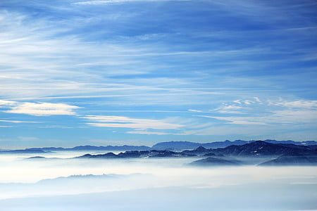 mountain range above clouds during daytime thumbnail