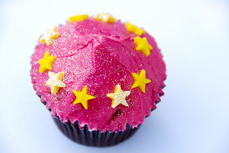 macro photography of pink cupcake with yellow star icings thumbnail