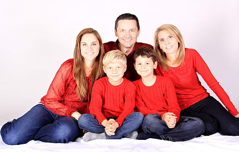 family wearing red long-sleeved shirts thumbnail