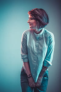 woman wearing white button-up long-sleeved shirt and gray denim bottoms thumbnail