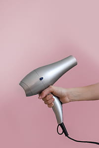 person holding silver hair dryer thumbnail