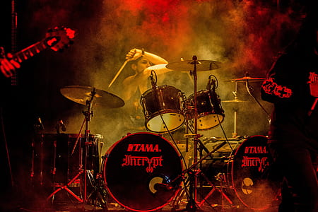 person wearing black tank-top playing acoustic drum set thumbnail