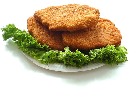 deep fried dish with vegetables on round white plate thumbnail