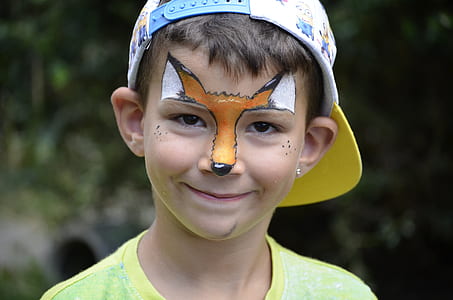 boy wearing yellow crew-neck shirt and white cap at daytime thumbnail