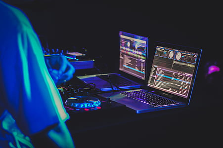 two laptop computers turned on and displaying music editor thumbnail