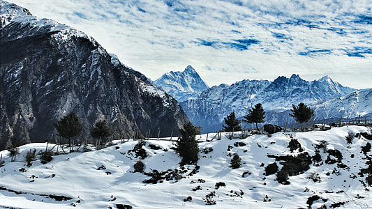 snow covered field at the foot of mountain thumbnail