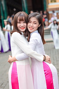 two women embracing each other during daytime thumbnail