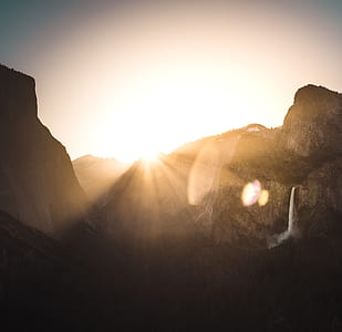 brown mountains against light at sunset thumbnail