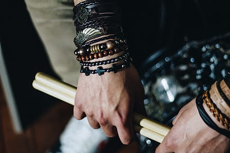 person holding drum sticks thumbnail