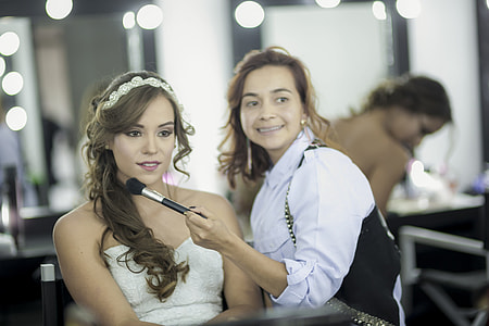 woman putting makeup on another woman's face thumbnail