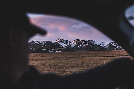 person sitting inside vehicle looking at the mountain thumbnail