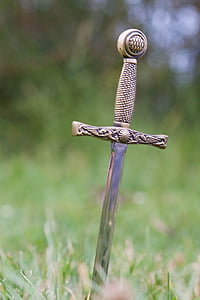 depth of field photography of sword in ground thumbnail