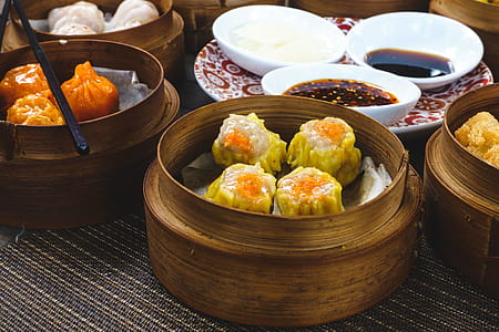 Chinese steamed and fried dim sum in wooden steamers thumbnail