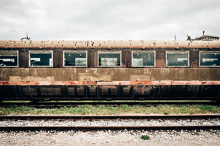 photo of rusted train on train tracks during daytime thumbnail