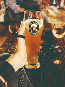 Person's Left Hand Holding Clear High Glass thumbnail