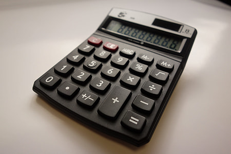 black desktop calculator on white surface thumbnail