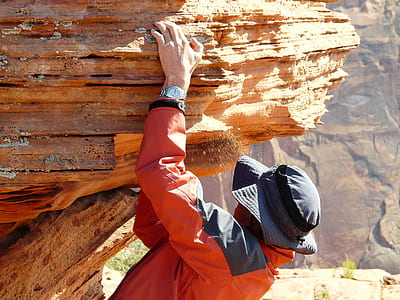 person touching brown rock thumbnail