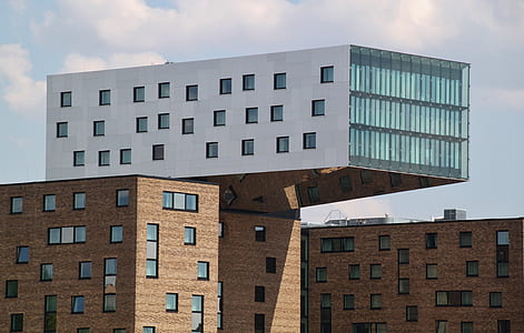white and brown concrete building under cloudy sky during daytime thumbnail