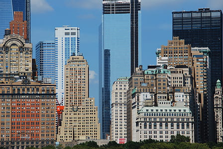 brown, white, and blue high-rise buildings during daytime thumbnail