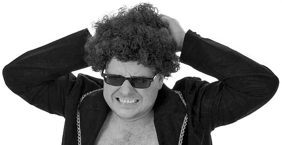 man wearing blazer holding hair thumbnail