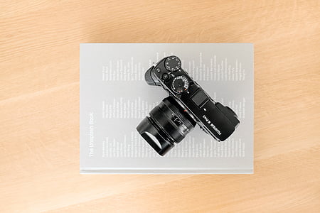 black DSLR camera on top of book thumbnail