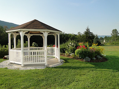 white and brown wooden gazebo in garden during daytime thumbnail