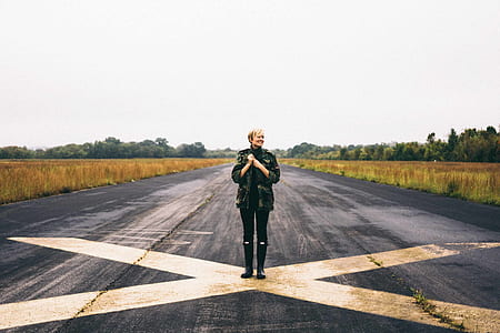 woman standing on road with x mark at daytime thumbnail