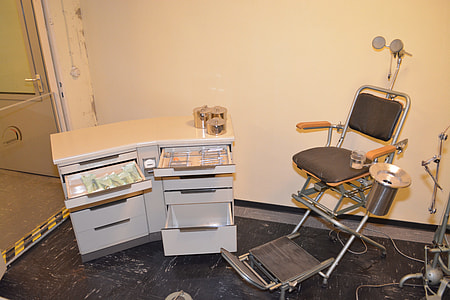 black dentist chair with grey wooden drawer chest thumbnail