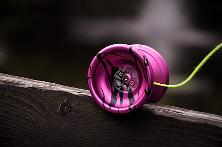 selective focus photography of pink and white yoyo thumbnail