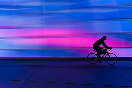 Silhouette of Person Riding on Commuter Bike thumbnail