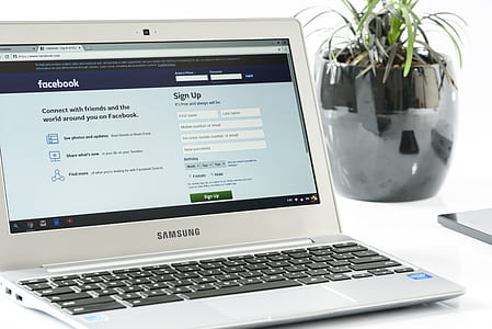 silver Samsung laptop beside green potted plant thumbnail