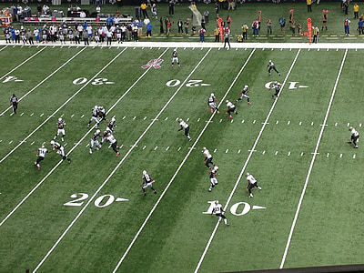 American players on field for a football game thumbnail