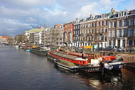 boat on water near city establishments thumbnail