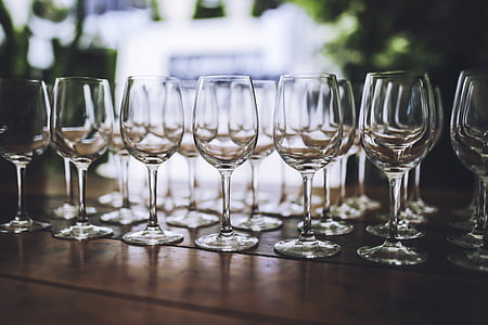 selective focus photography of clear wine glass lot on top of brown wooden table thumbnail