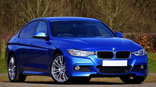 blue BMW sedan on road at daytime thumbnail