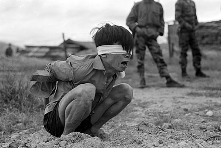 Viet Cong prisoner captured in 1967 by the U.S. Army awaits interrogation during Vietnam War thumbnail