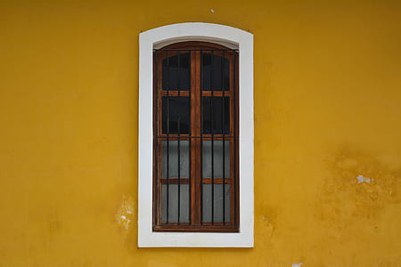 mirror with brown wooden frame install in yellow and white wall thumbnail