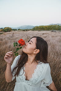 woman smelling red rose thumbnail