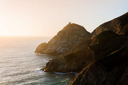 cliff beside body of water thumbnail