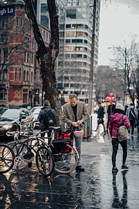 man carrying helmet in front of bicycle outdoor thumbnail