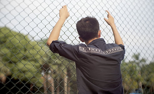 man holding fence thumbnail