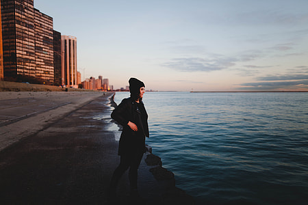 woman standing in front of body of water thumbnail