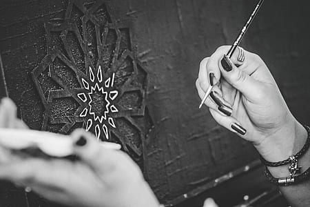 Black and White Photo of Hands Holding a Paintbrush thumbnail