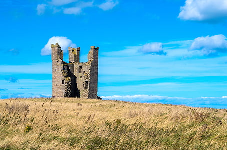 gray concrete castle in field during daytime thumbnail