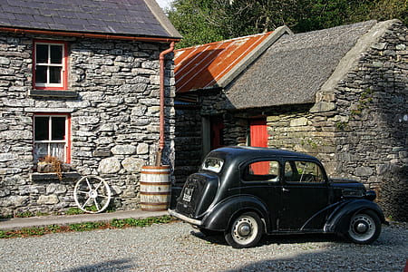 classic black car parked near house thumbnail