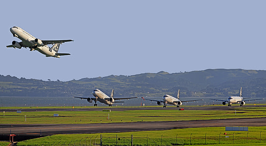four airliners about to fly under blue sky thumbnail
